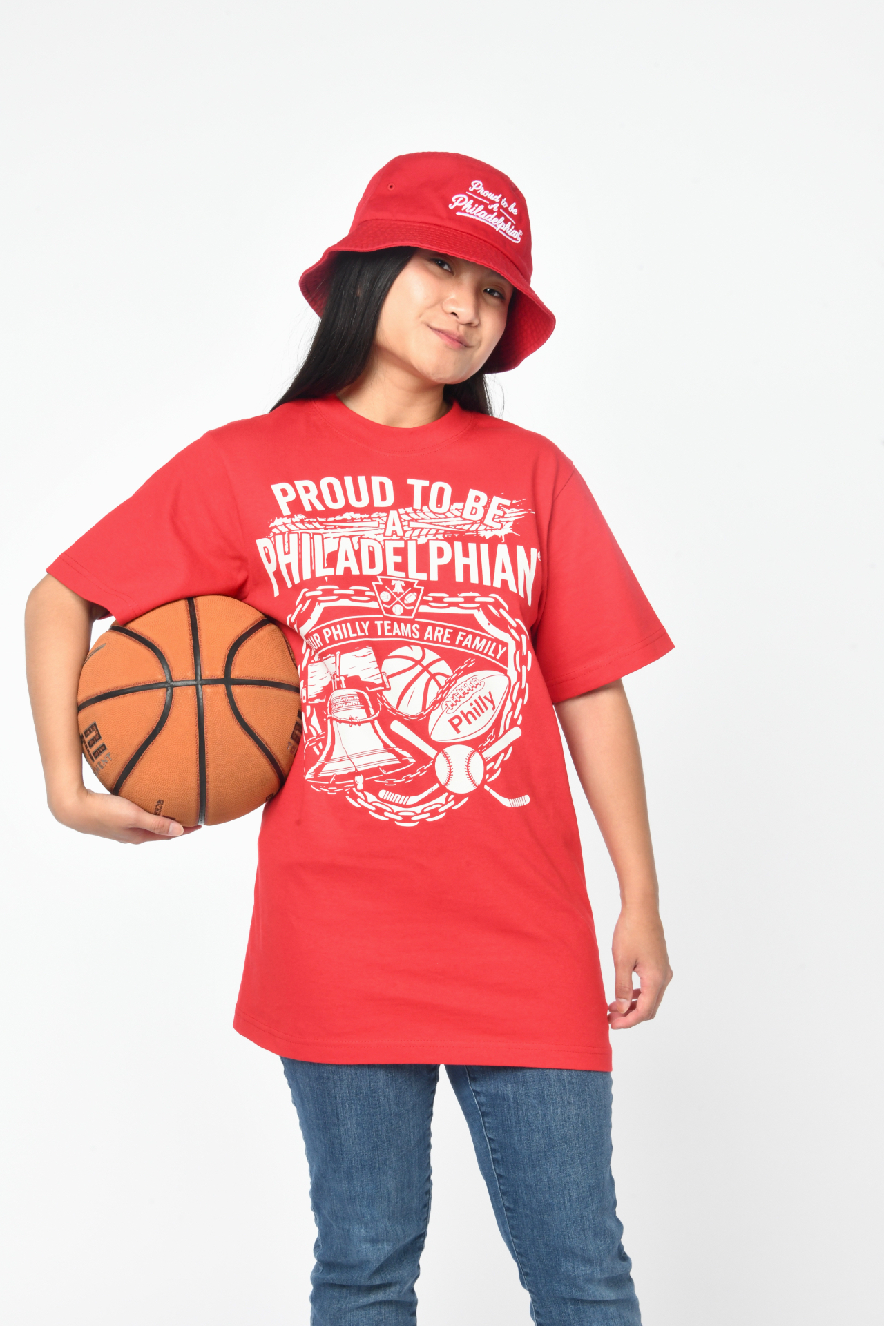Model wearing the red Unbreakable Loyalty Tee with a basketball