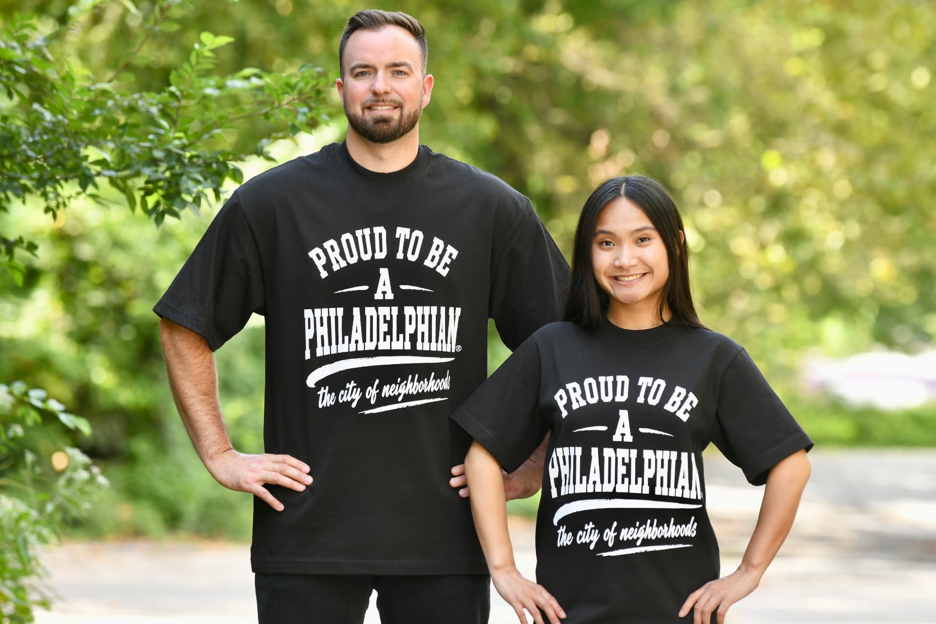 Models wearing the City of Neighborhoods tee outdoors